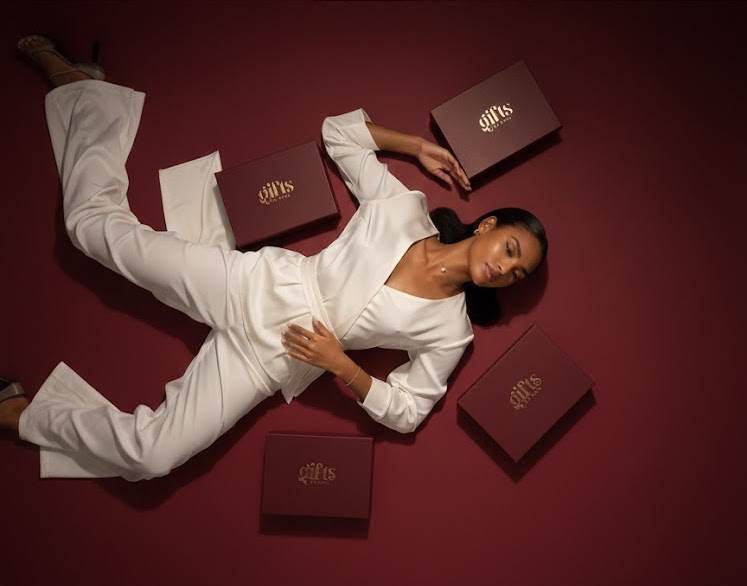 gifts by dora overhead shot with boxes and a caramel skin lady wide